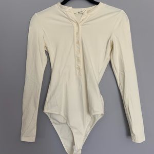 Light cream Reformation body suit.
